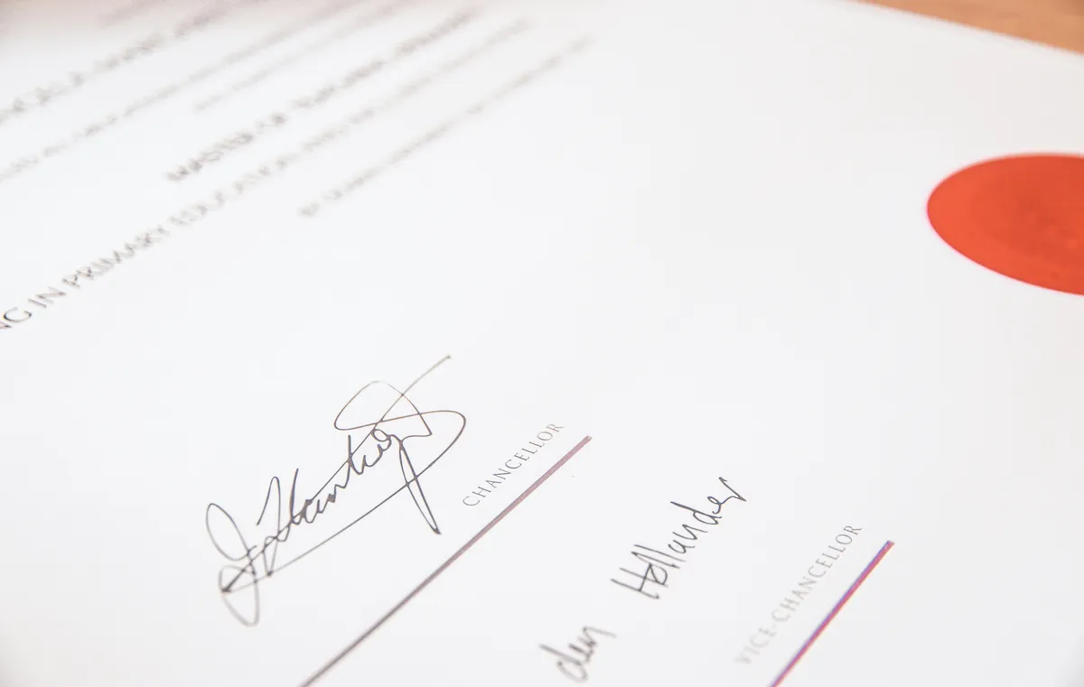 Close-up of a signed certificate with an embossed red seal